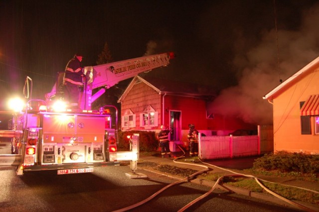 Structure fire on Correja Avenue November 13, 2008. Ex-Chief Christensen sends the aerial to the roof.